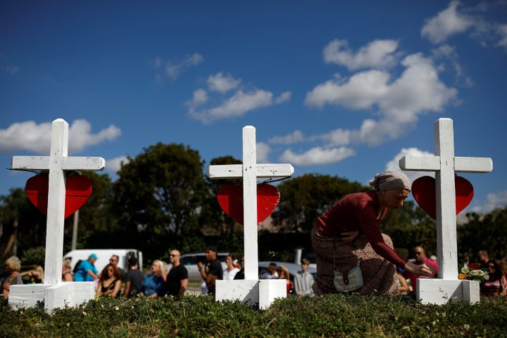 Elena Wright mourns shooting victims at a memorial in front of Marjory Stoneman Douglas High School in Parkland, Florida, on Feb. 18, 2018.