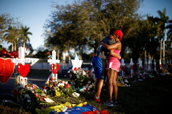 Marjory Stoneman Douglas High School student Adin Chistian, 16, embraces his mother, Denyse, at the memorial to victims of the Parkland shooting on Feb. 19, 2018.