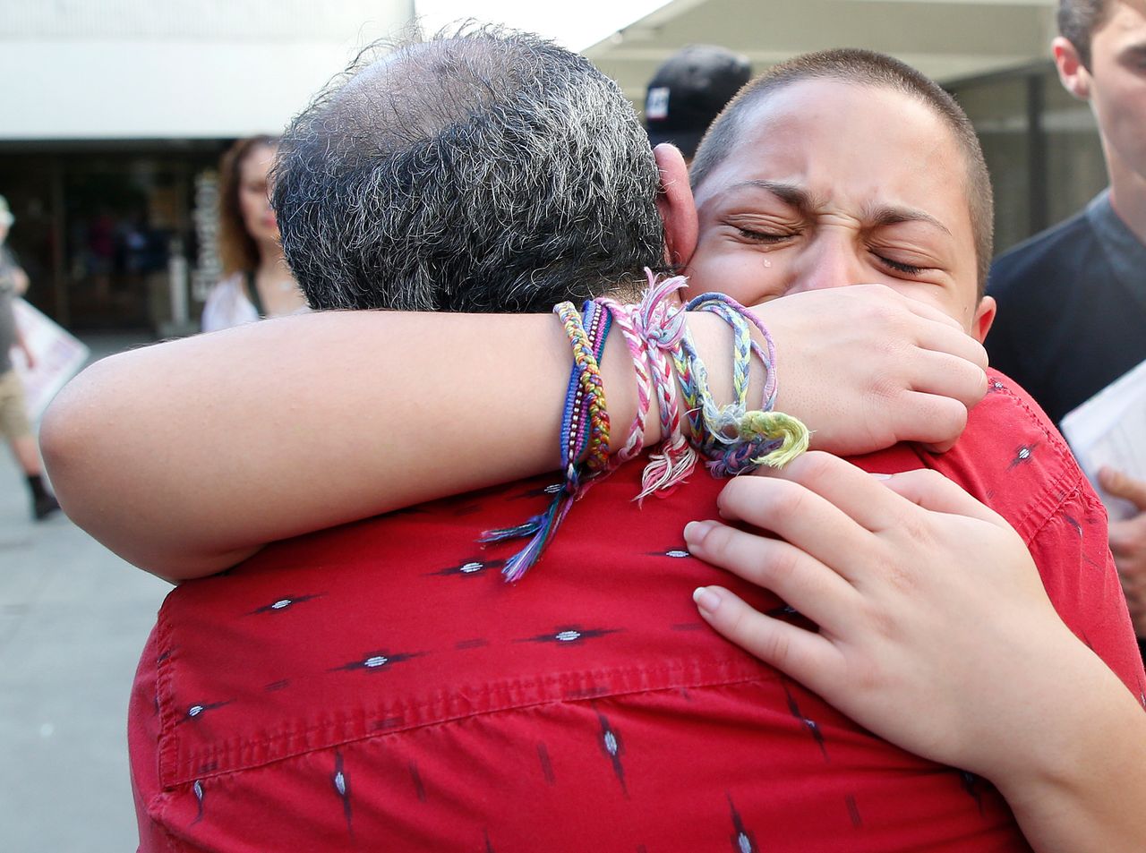 Marjory Stoneman Douglas High School student Emma González hugs her father Jose after speaking at a rally for gun control at the Broward County Federal Courthouse in Fort Lauderdale, Florida on Feb. 17, 2018.