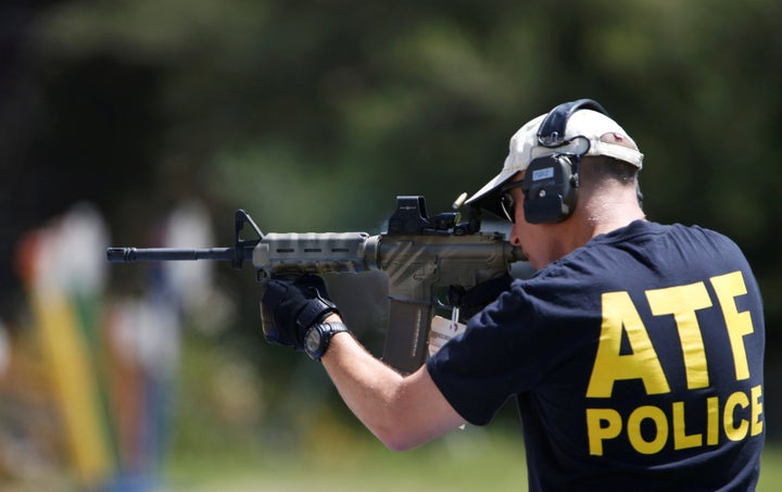 An officer of the Bureau of Alcohol, Tobacco, Firearms and Explosives fires a weapon used in several crimes to collect c