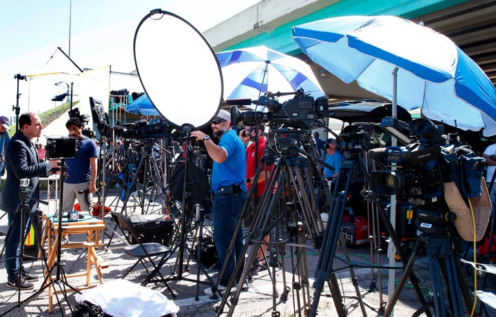 Members of the media line up on the roadway to Marjory Stoneman Douglas High School in Parkland, Florida, on Feb. 16, two days after the mass shooting there.