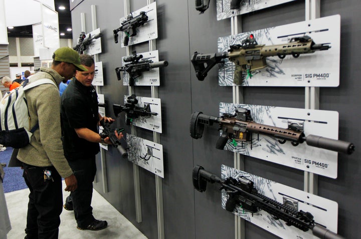 Gun enthusiasts view Sig Sauer rifles at the National Rifle Association's annual meetings and exhibits show in Louisville, Kentucky on May 21, 2016.