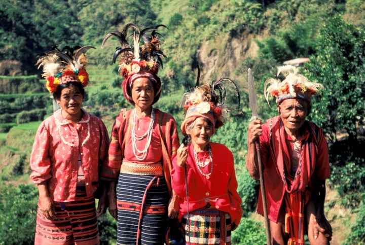 Ifugao women show their traditional costumes as they stand among rice terraces built by their ancestors and maintained by the tribe.