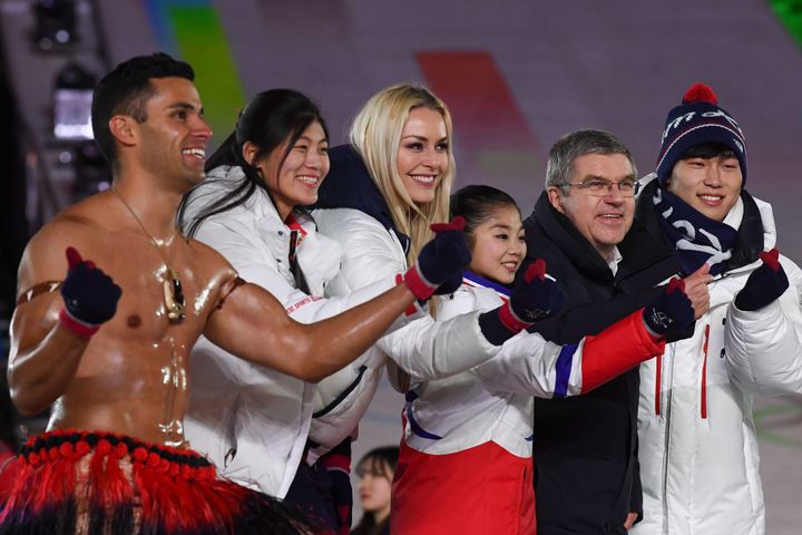 Taufatofua joined China's Liu Jiayu, USA's Lindsey Vonn, North Korea's Ryom Tae-ok, International Olympic Committee President Thomas Bach and South Korea's Yun Sungbin to make heart shapes with their fingers during the closing ceremony of the Winter Olympics.