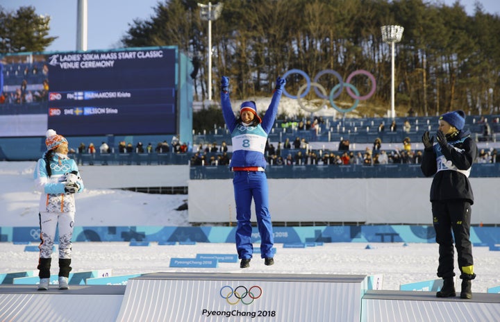 Gold medallist Marit Bjoergen of Norway is seen flanked by silver medallist Krista Parmakoski of Finland and bronze medallist Stina Nilsson of Sweden.