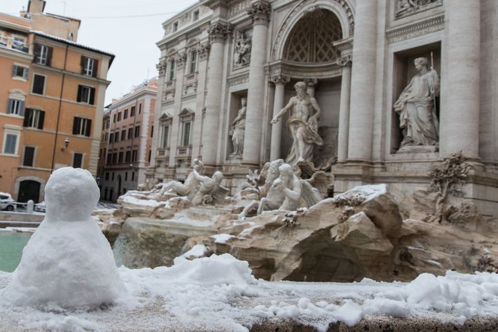 Overnight snowfall has also blanketed Italy's capital Rome. Pictured is the Trevi Fountain 