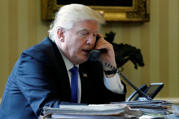 U.S. President Donald Trump speaks by phone with Russia's President Vladimir Putin in the Oval Office at the White House on Jan. 28, 2017.