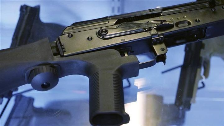 A bump stock is attached to a semi-automatic rifle at the Gun Vault store and shooting range in South Jordan, Utah.