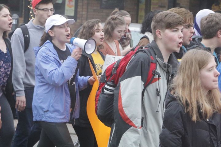 High school students march in the streets of Iowa City last week as part of a walkout to call for stricter gun control policies.