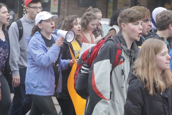 High school students march in the streets of Iowa City last week as part of a walkout to call for stricter gun control policies.