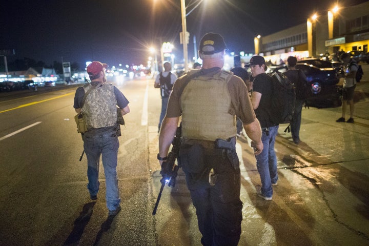 Oath Keepers carry rifles in Ferguson, Missouri, on Aug. 10, 2015. Demonstrators were protesting there on the first anniversary of the fatal shooting of unarmed black teenager Michael Brown.