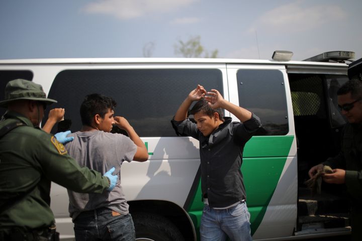 U.S. Border Patrol agents detain men in Roma, Texas, last May after they entered the U.S. by crossing the Rio Grande from Mexico.