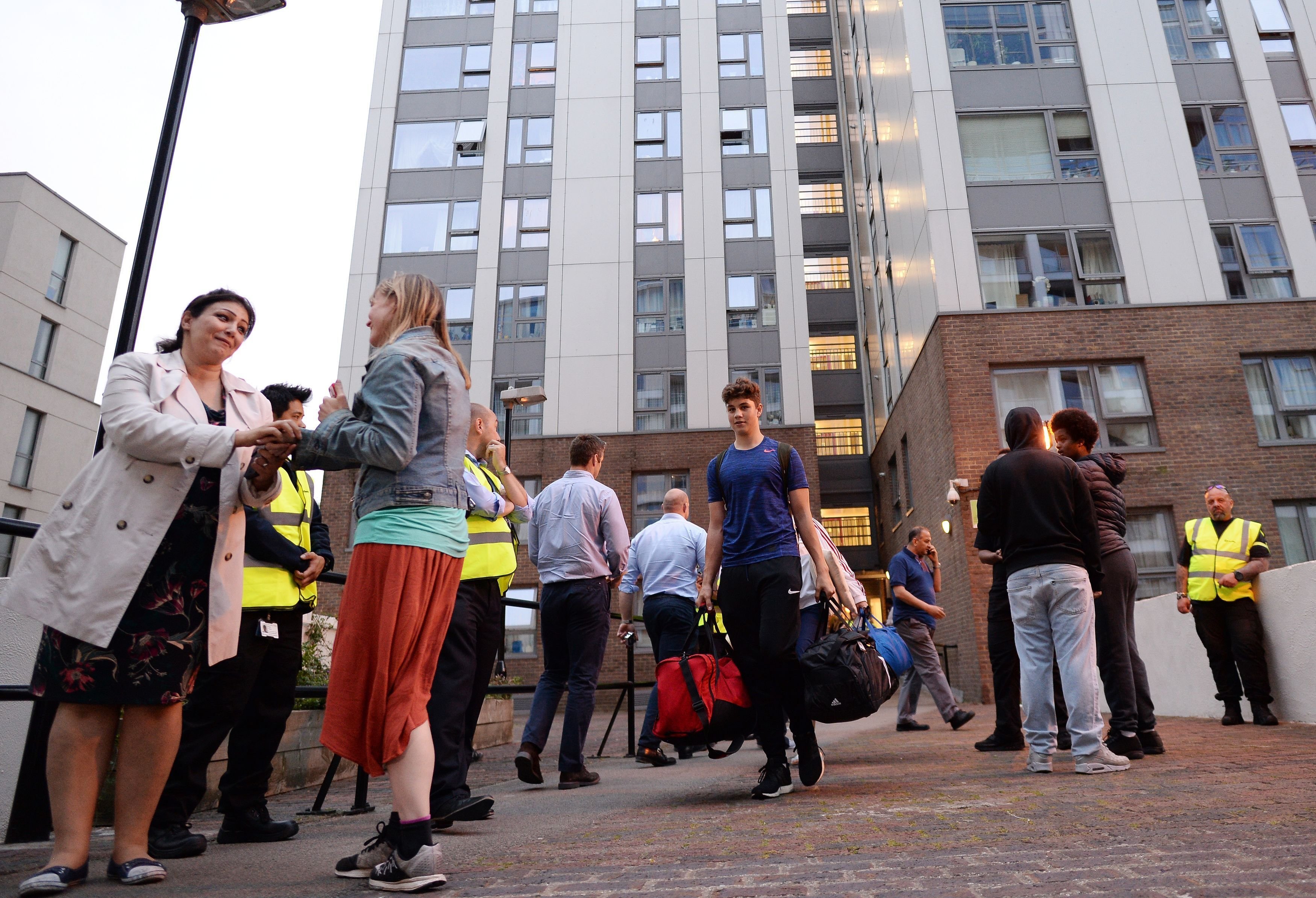 <strong>Residents leave the Taplow tower block on the Chalcots Estate in Camden, London, as the building is evacuated in the wake of the Grenfell Tower fire to allow "urgent fire safety works" to take place.</strong>