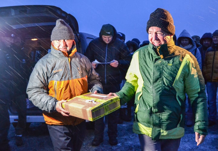 Ivan Matus (L) and Fernando Ortega from Chile carry a package containing seeds from their country to deposit at the Global Seed Vault on Monday.