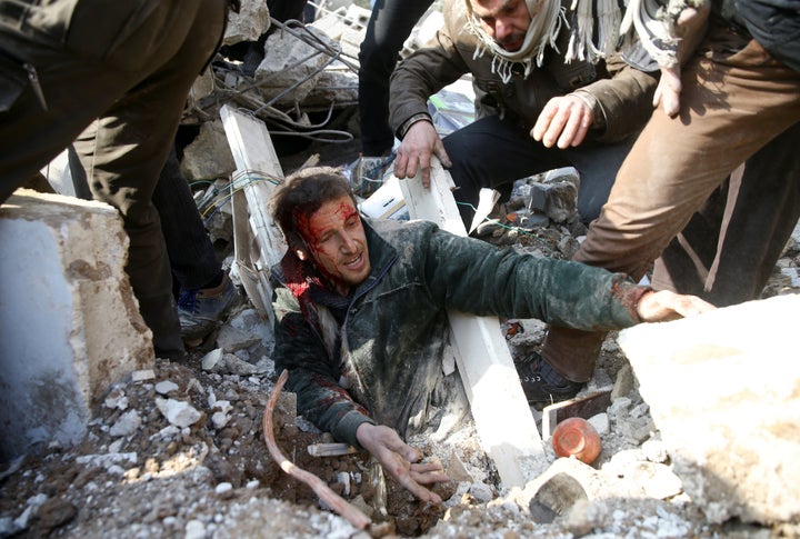 A man is stuck under debris after an airstrike in the eastern Damascus suburb of Ghouta, Syria, on Jan. 9, 2018.