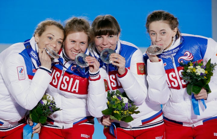 Silver medalists Olga Zaitseva, far left, Yana Romanova, Ekaterina Shumilova and Olga Vilukhina of Russia pose during the ceremony at the 2014 Winter Olympics in Sochi. 