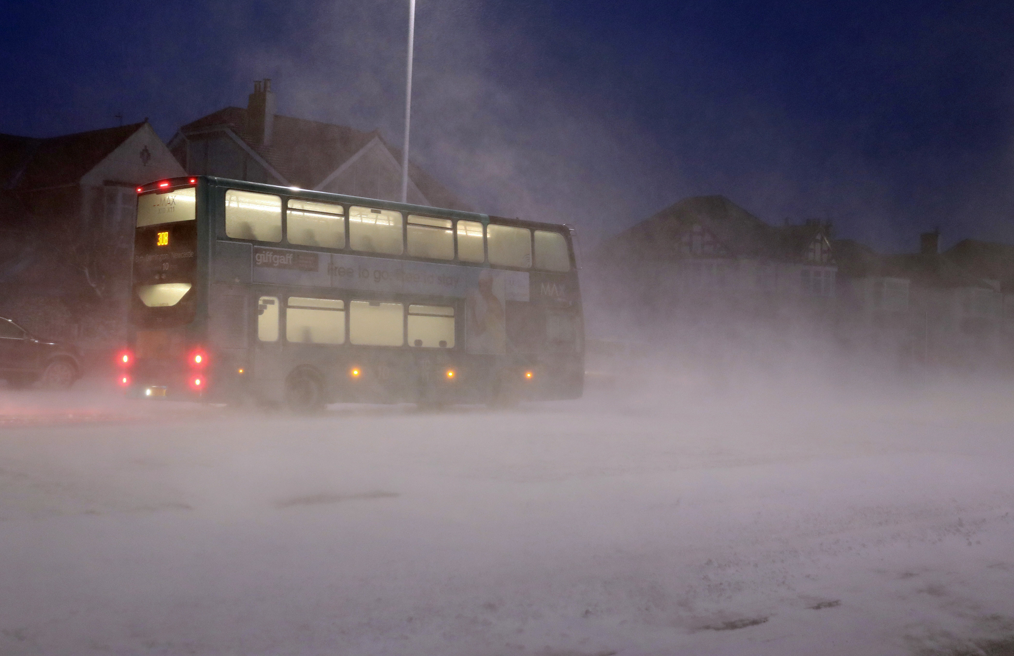 <strong>A bus passes through a snow storm in Whitley Bay as heavy snow has caused more misery for travellers overnight.</strong>