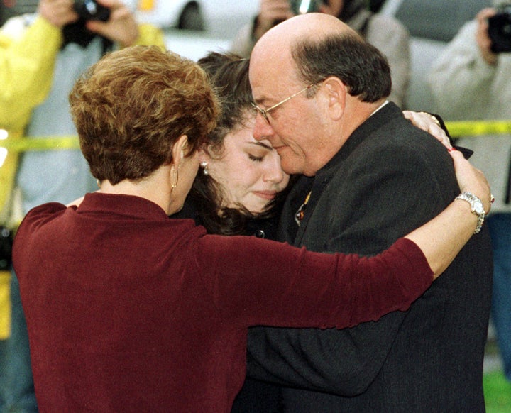 Moica Lewinsky is hugged by her father, Bernard, and an unidentified woman in February 1998.