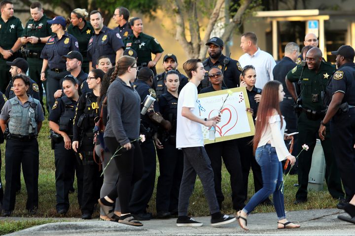 Police and law enforcement show their support as students arrive at Marjory Stoneman Douglas High School on Wednesday.