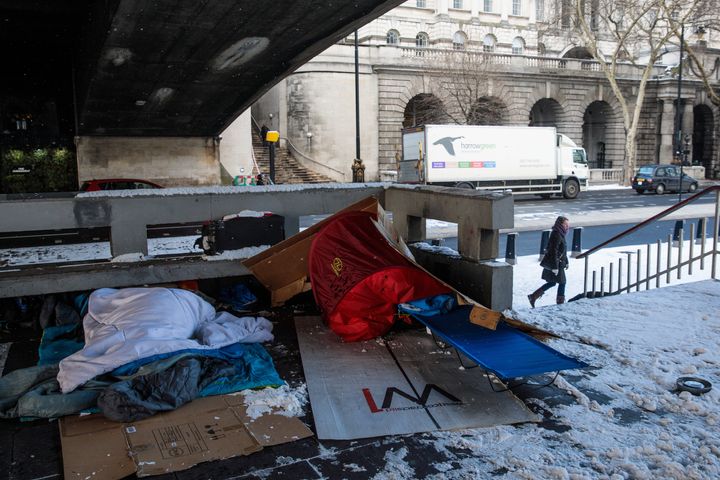 Bedding and shelters belonging to homeless people lie under a bridge on the Embankment in London.