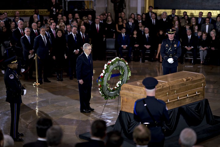 Senate Majority Leader Mitch McConnell (R-Ky.) stands near the casket of the late Rev. Billy Graham during a service at the U.S. Capitol on Wednesday.