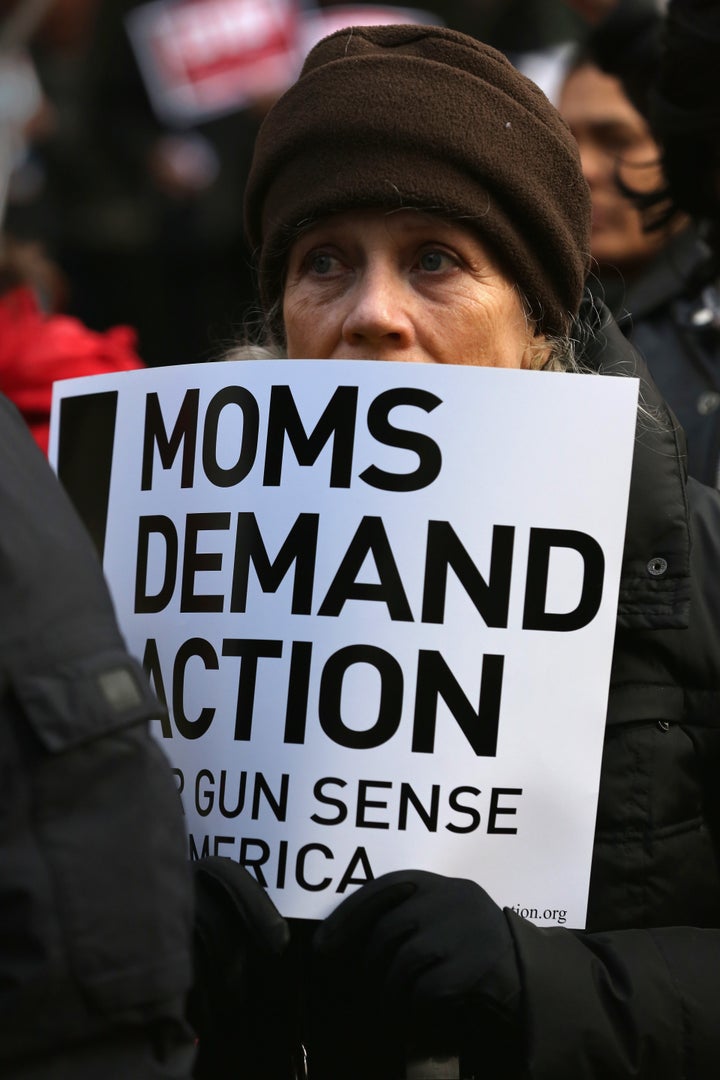Demonstrators promote New York Gov. Andrew Cuomo's NY SAFE Act during a rally against gun violence on March 21
