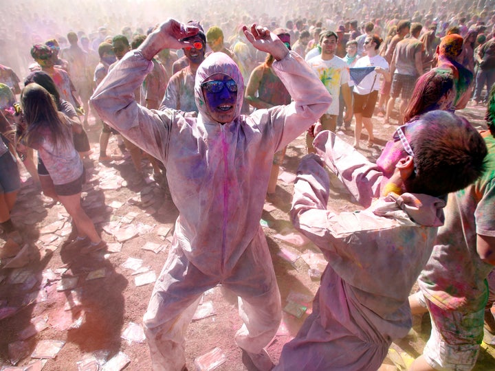 Participants dance and throw colored chalk during the Holi Festival of Colors at the Sri Sri Radha Krishna Temple in Spanish Fork, Utah, March 30, 2013. 