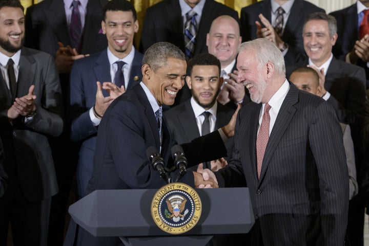 Then-President Barack Obama shares a laugh with San Antonia Spurs coach Gregg Popovich when the team visited the White House in 2015 to celebrate its 2014 NBA title.