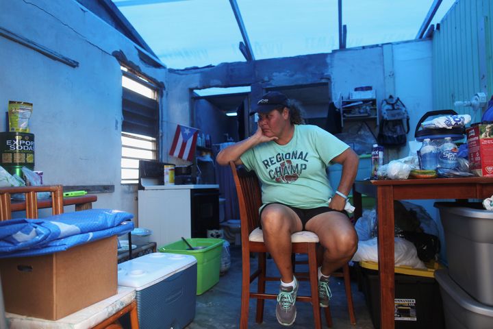 Jazmin Morales sits in her kitchen on Jan. 29 without power and with a plastic sheet replacing the roof in Yabucoa, Puerto Rico, after Hurricane Maria hit the island.
