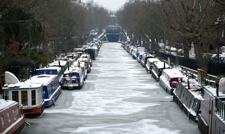 Canal boats frozen at their berths on the Regent's Canal in Maida Vale in London 