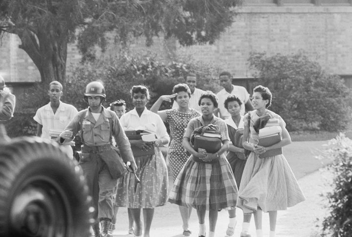 Members of the Little Rock Nine leave Central High School at the end of a school day.