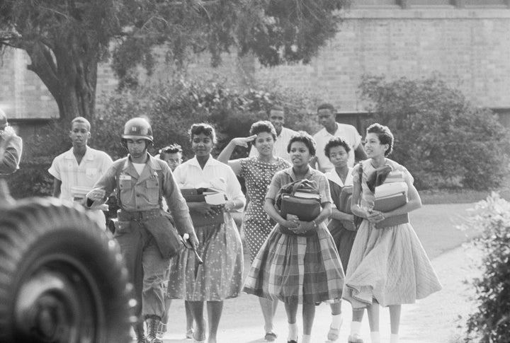 Members of the Little Rock Nine leave Central High School at the end of a school day.