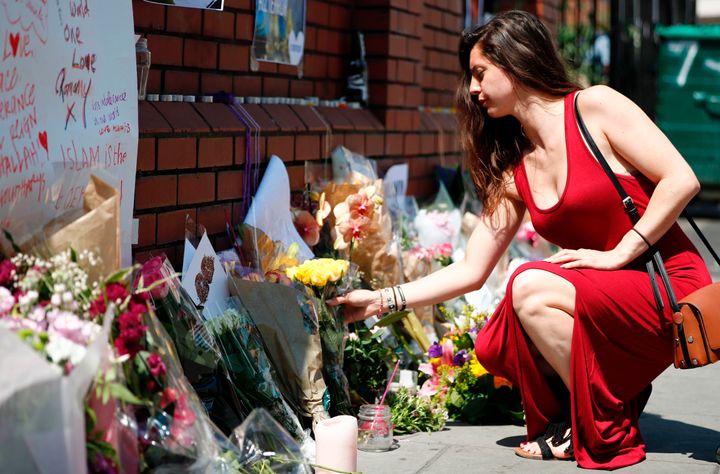 A woman lays flowers in tribute outside of Finsbury Mosque in the Finsbury Park area of north London.