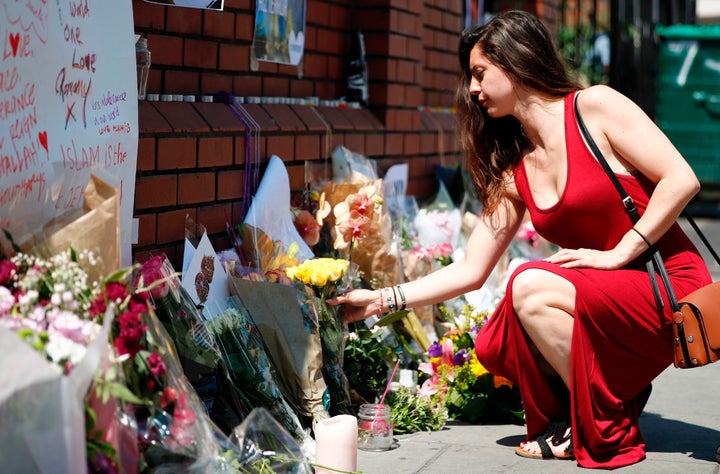 <strong>A woman lays flowers in tribute outside of Finsbury Mosque in the Finsbury Park area of north London.</strong>