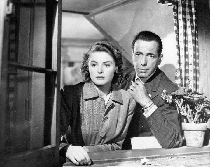 Ingrid Bergman and Humphrey Bogart look out a window in a scene from the 1942 film