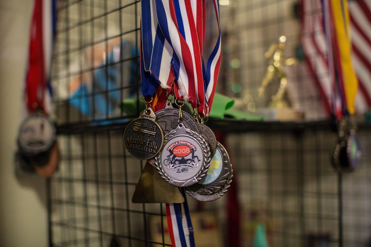 Trophies, plaques, ribbons, medals and other mementos from Yarling's triathlon racing career are displayed at his home.