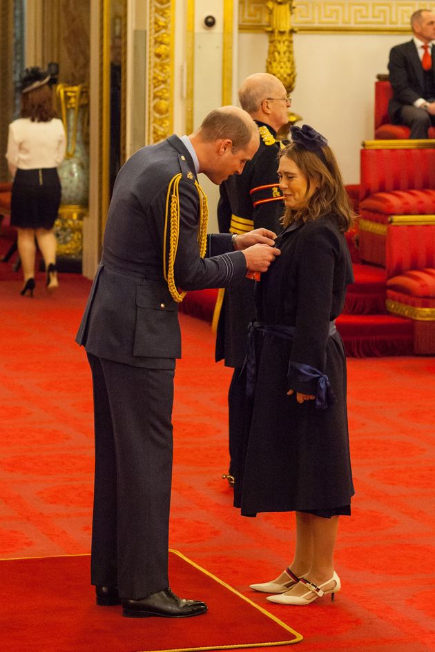 Former editor of British Vogue Alexandra Shulman, pictured above receiving her CBE from the Duke of Cambridge, has said Meghan Markle will bring a touch of American 'sassiness' to the look of the royal family