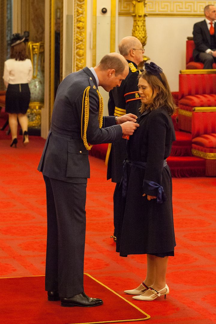 Former editor of British Vogue Alexandra Shulman, pictured above receiving her CBE from the Duke of Cambridge, has said Meghan Markle will bring a touch of American 'sassiness' to the look of the royal family