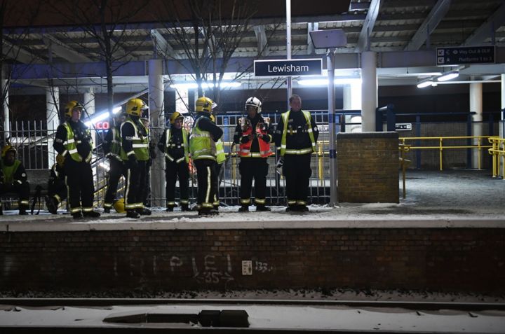 Emergency workers at Lewisham station after passengers frustrated by delays jumped from trains and walked down tracks near the station