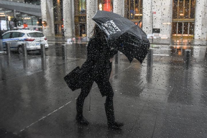 A person walks in the rain during a large storm on March 2 in New York, New York.