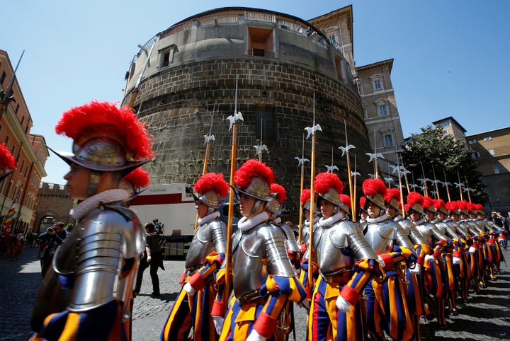 New recruits of the Vatican's elite Swiss Guard march in front of the tower of the Institute for Works of Religion (IOR) during the swearing-in ceremony at the Vatican May 6, 2014.