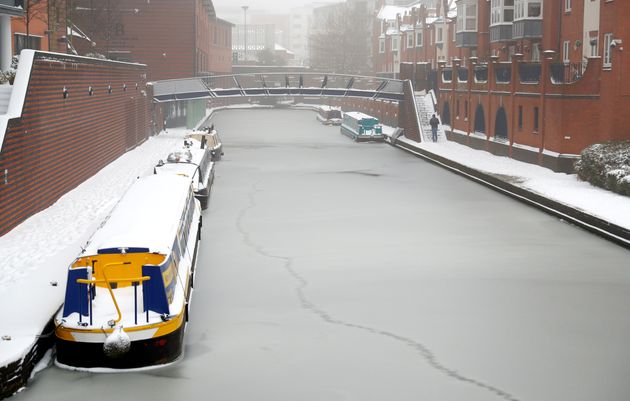 Canal boats remain moored in the frozen canal in Birmingham