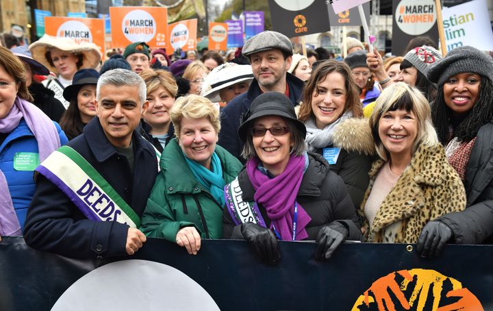 Marchers including Mayor of London Sadiq Khan, Sandi Toksvig, Michael Sheen and Helen Pankhurst (fourth right with purple scarf) gather outside the Palace of Westminster