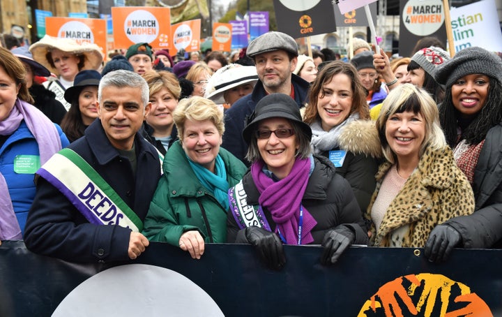 Marchers including Mayor of London Sadiq Khan, Sandi Toksvig, Michael Sheen and Helen Pankhurst (fourth right with purple scarf) gather outside the Palace of Westminster