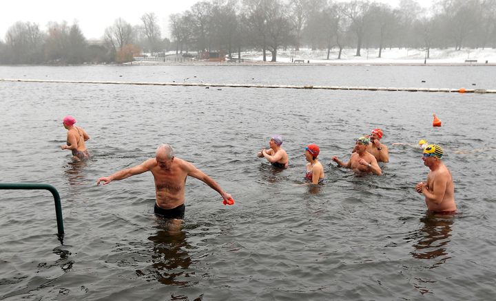 Swimmers emerge from the Serpentine lake in Hyde Park in London.
