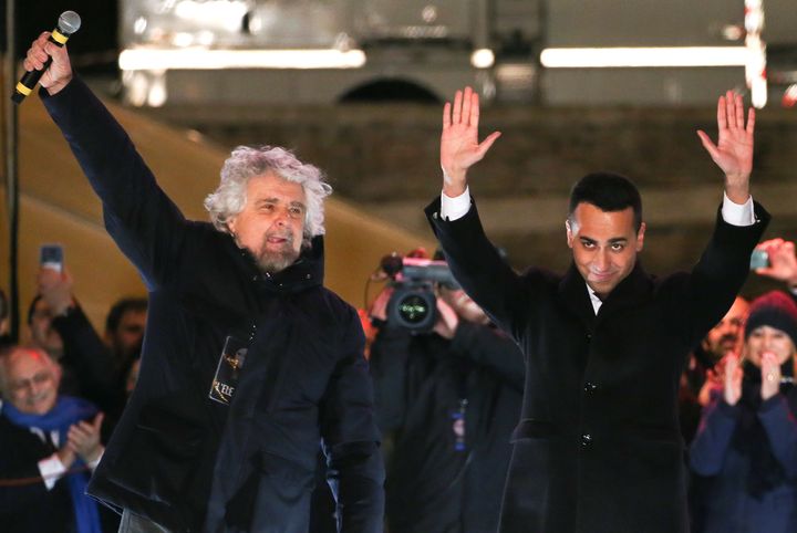 5-Star Movement founder Beppe Grillo waves with leader Luigi Di Maio during the finally rally ahead of the March 4 elections in downtown Rome.