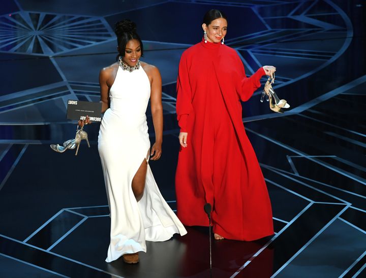Actors Tiffany Haddish (left) and Maya Rudolph walk onstage during the 90th Annual Academy Awards.