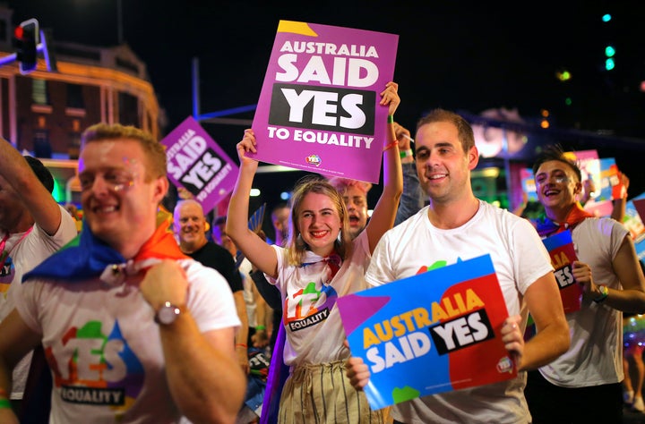 Participants hold banners regarding same-sex marriage during the 40th anniversary of the Sydney Gay and Lesbian Mardi Gras Pa
