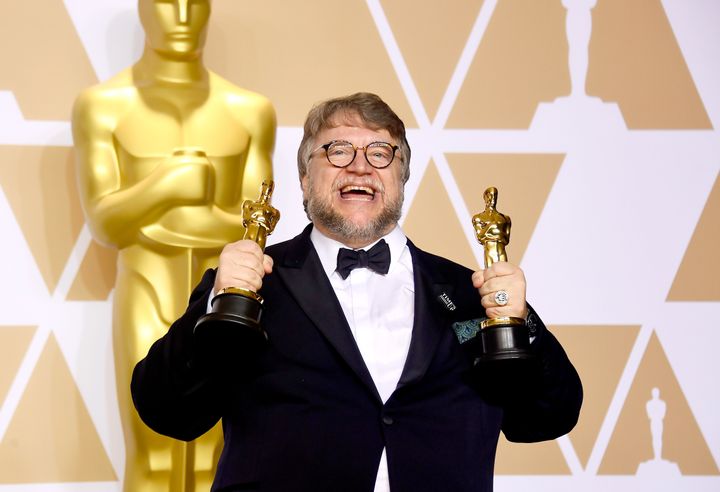 Guillermo del Toro holds his trophies for Best Picture and Best Director.