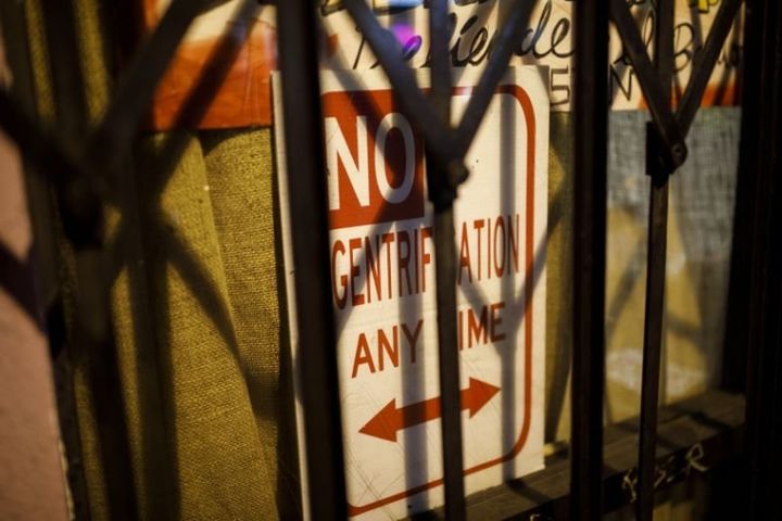A sign saying “No Gentrification Any Time” is dispayed in the window of the La Conxa Autonomous Community Space in Boyle Heights, Los Angeles. 
